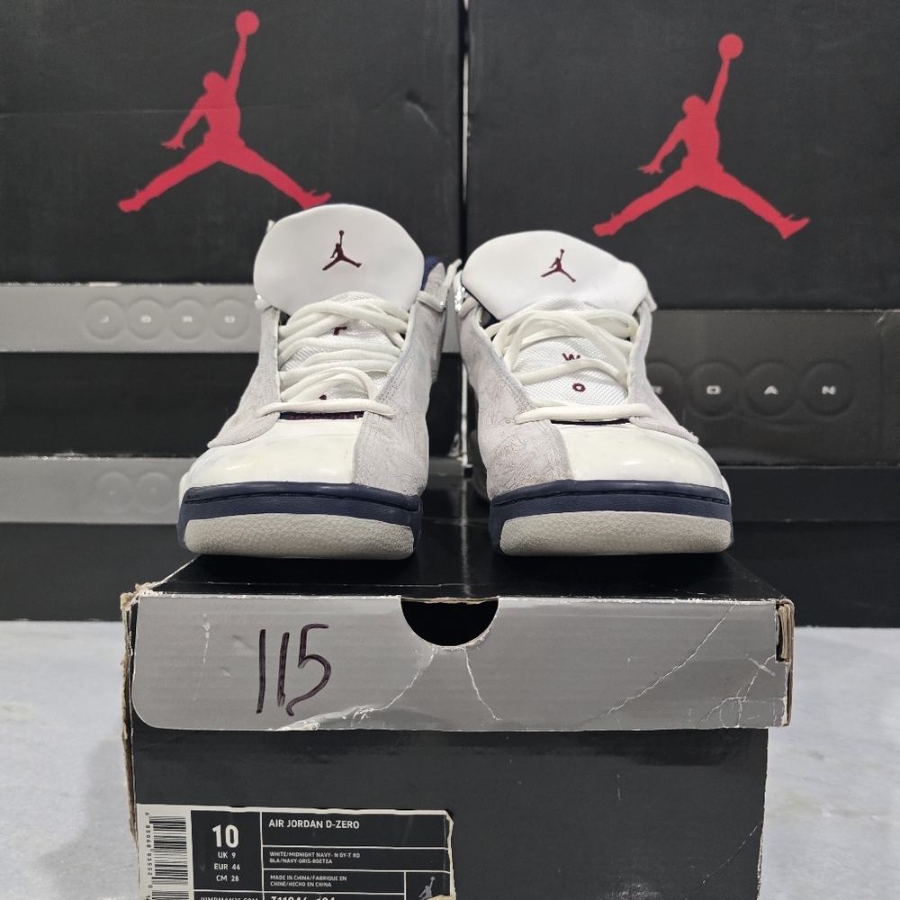This is a pair of Jordan Dub Zero sneakers in a white, neutral grey, black, and